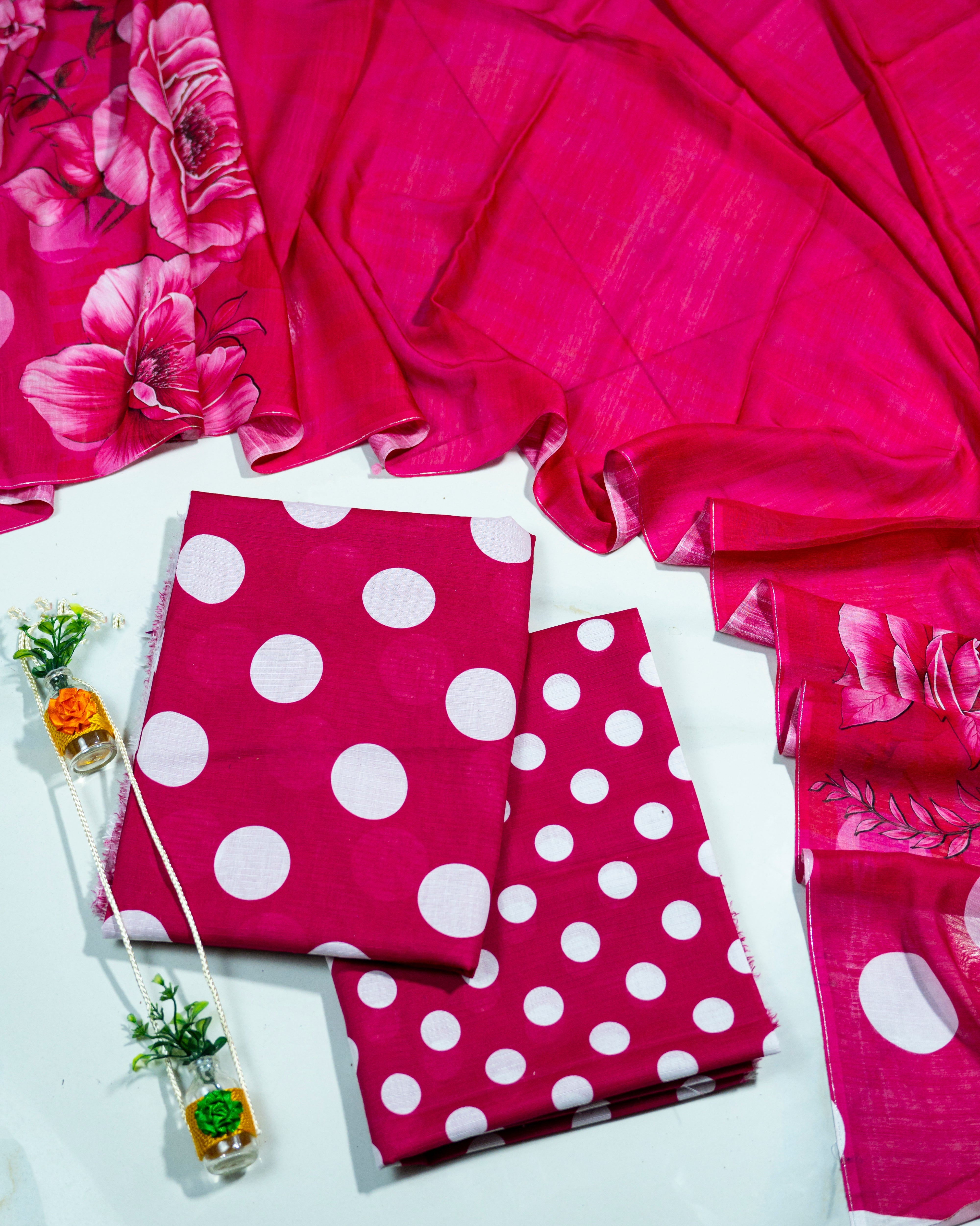Pink fabric with white polka dots on a white background