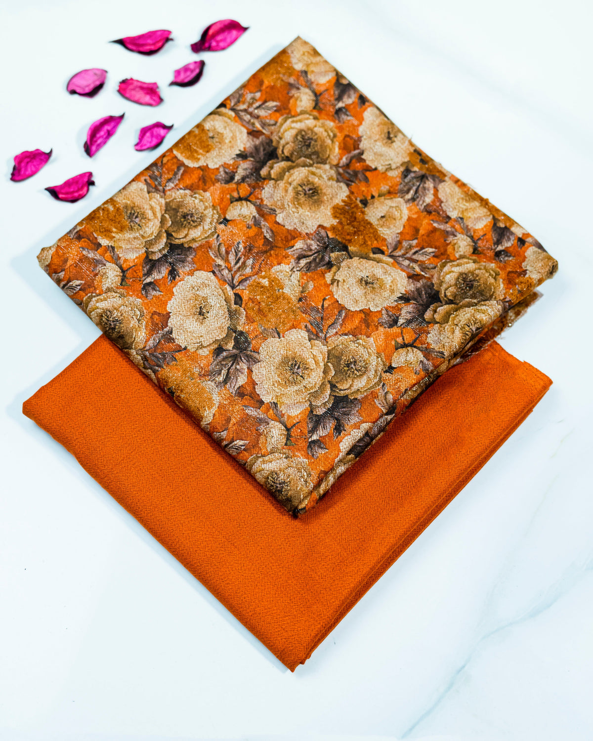 Floral fabric on an orange square with pink petals on a white background