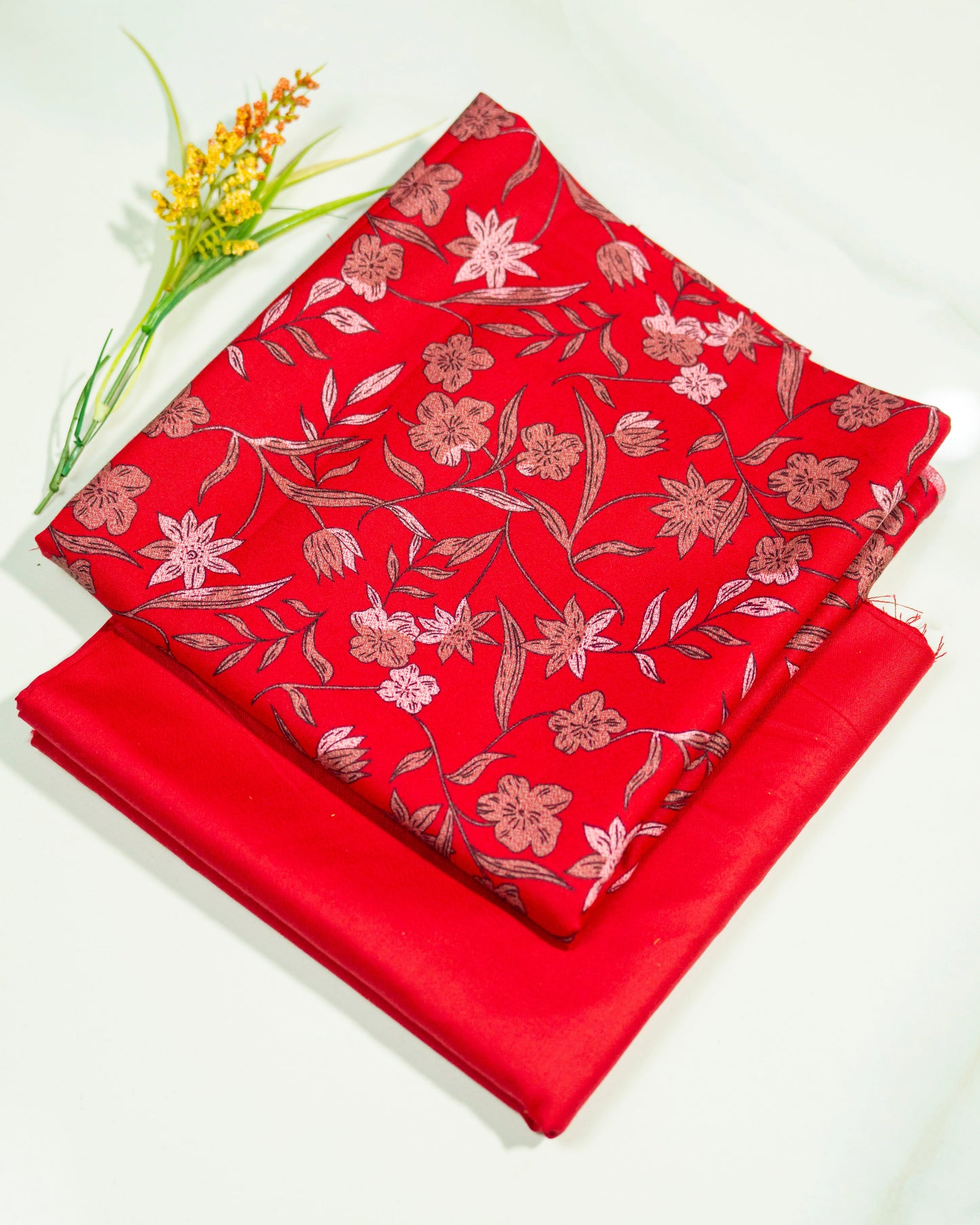 Red fabric with floral pattern on a white background