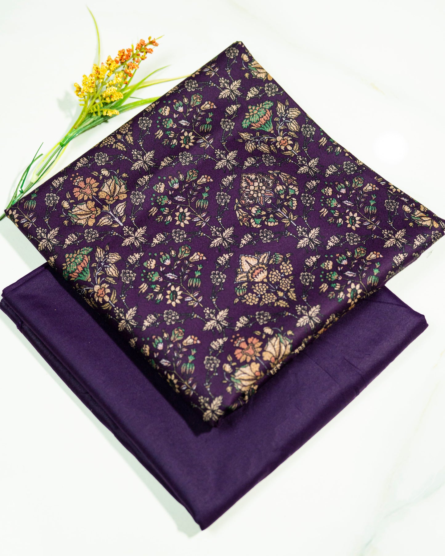 Purple fabric with floral pattern on a white background