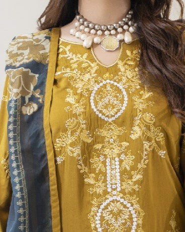 Yellow embroidered dress with intricate patterns and a necklace on a plain background