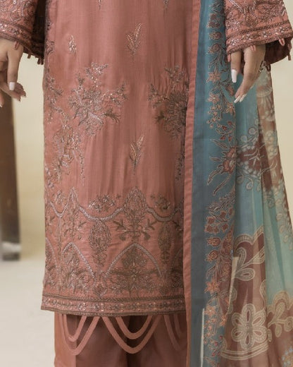 Detailed border view of Lilli’s shirt hem embroidery revealing elegant motifs and design work