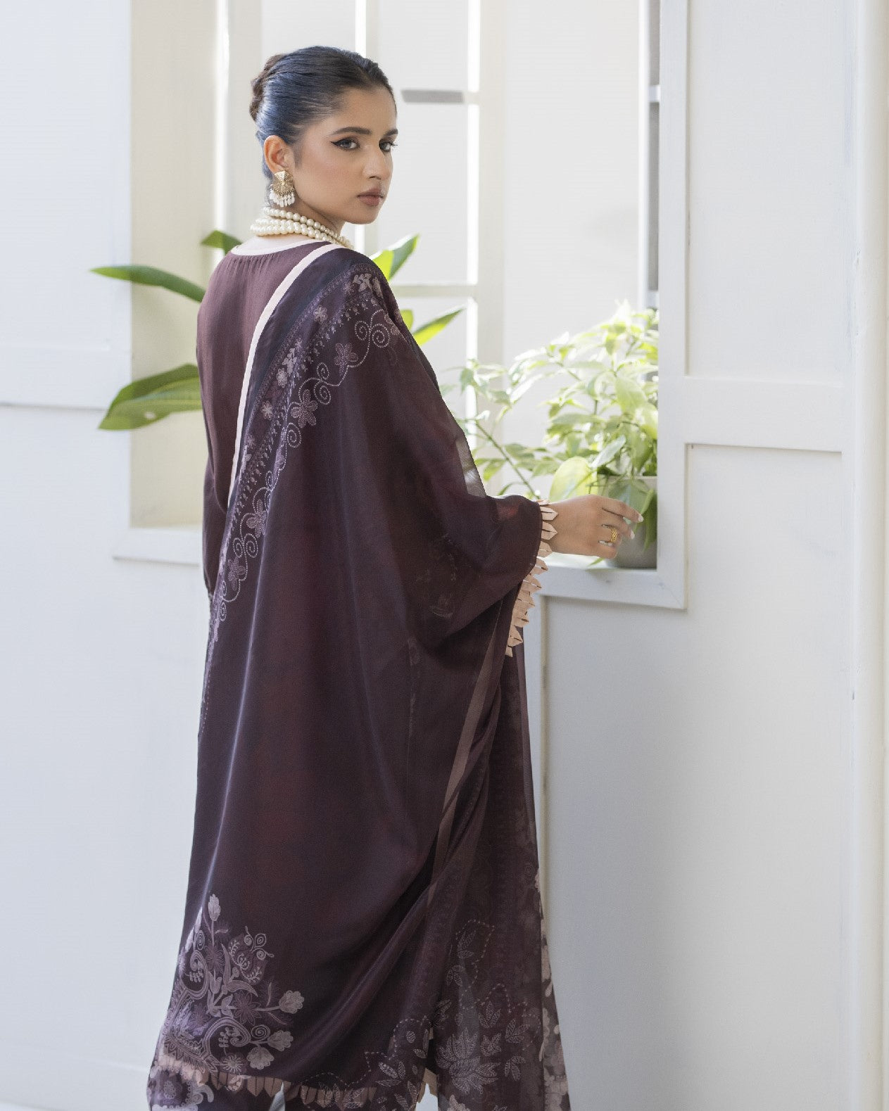 Back view of Maha showing embroidered back panel of shirt with coordinated dupatta and trouser
