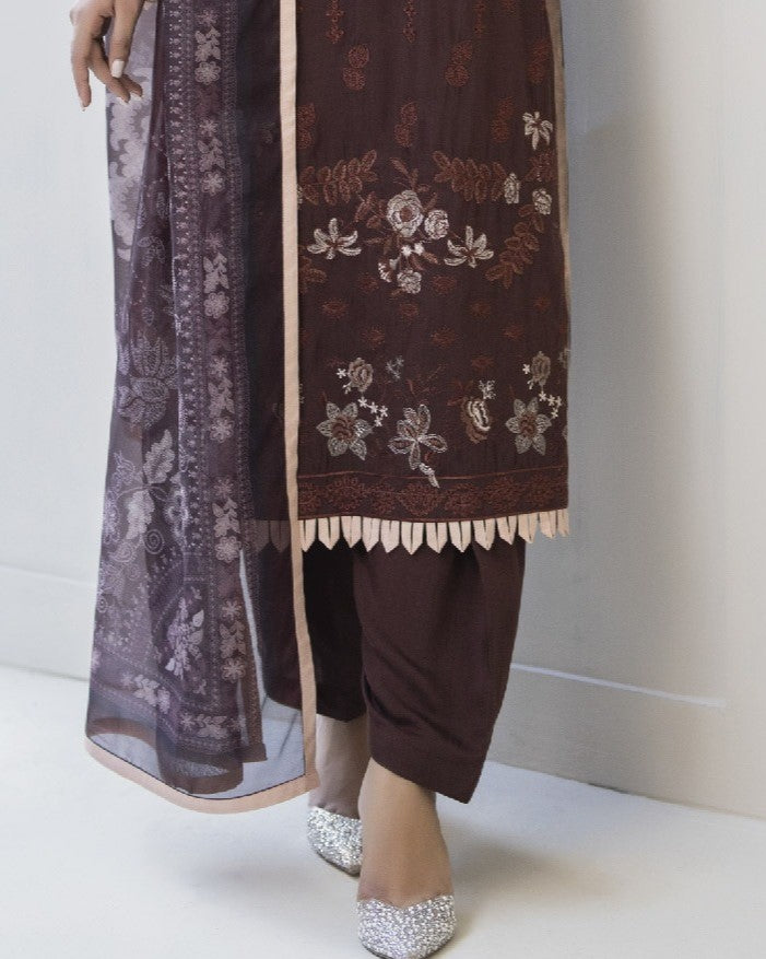 Detailed border view of Maha’s shirt hem embroidery revealing refined motifs and design work