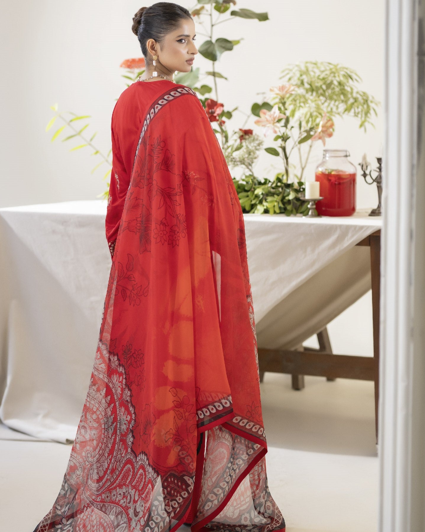 Back view of Miran showing embroidered back panel of shirt with coordinating trouser and dupatta