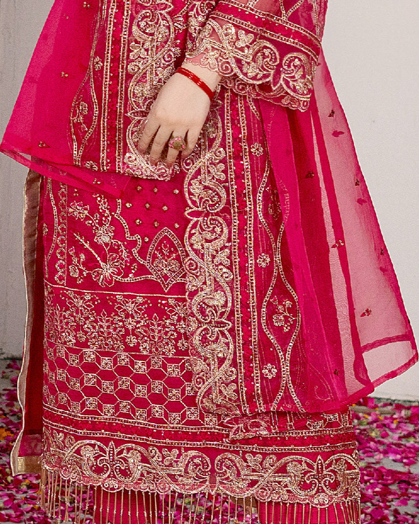 Detailed border view of Surkh Gul, showcasing exquisite embroidery with traditional threadwork and intricate patterns along the hemline, accentuating the formal allure of the ensemble.